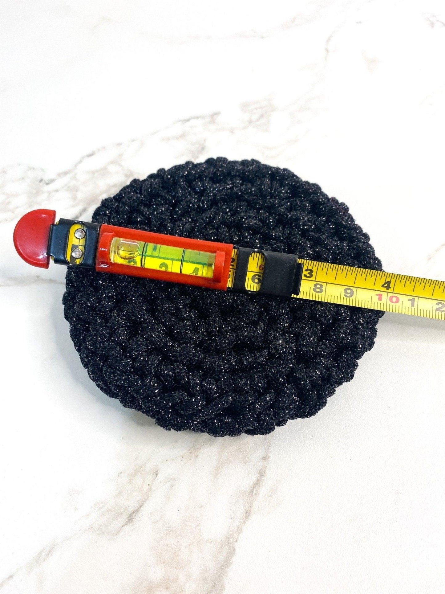 Handmade Black Crochet Dish Scrubby with Yellow Measuring Tape Across it
