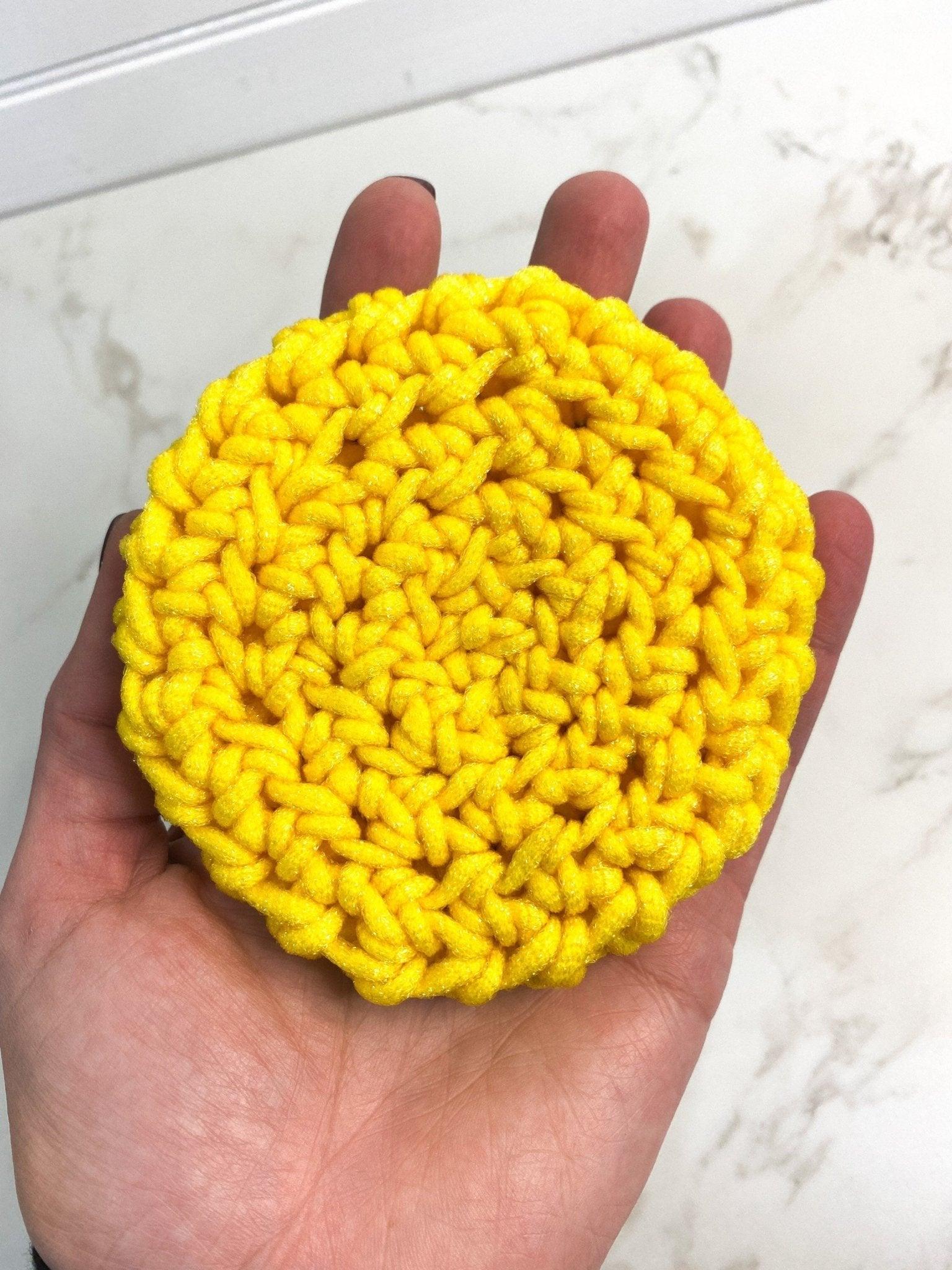 Human Hand Holding Bright Yellow Crochet Dish Scrubby