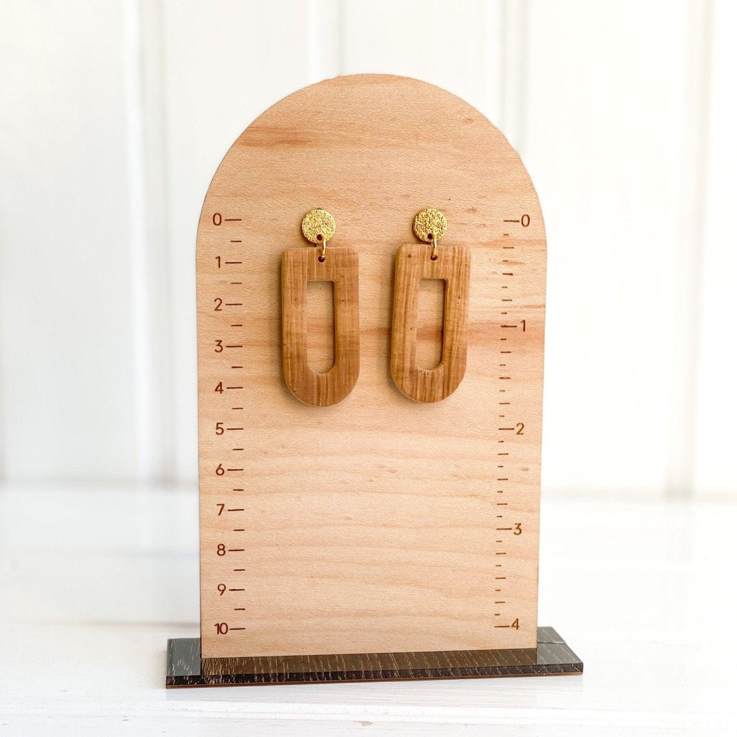 cute handmade brown earrings with gold surgical steel posts on wood measurement stand