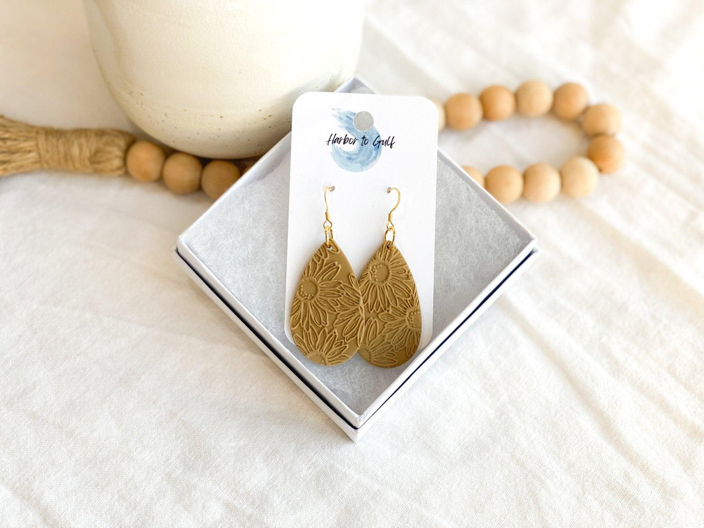 Handmade, Neutral Color Teardrop Shaped Earrings with Embossed Daisy Print on Gold Surgical Steel Ear Wires in Gift Box