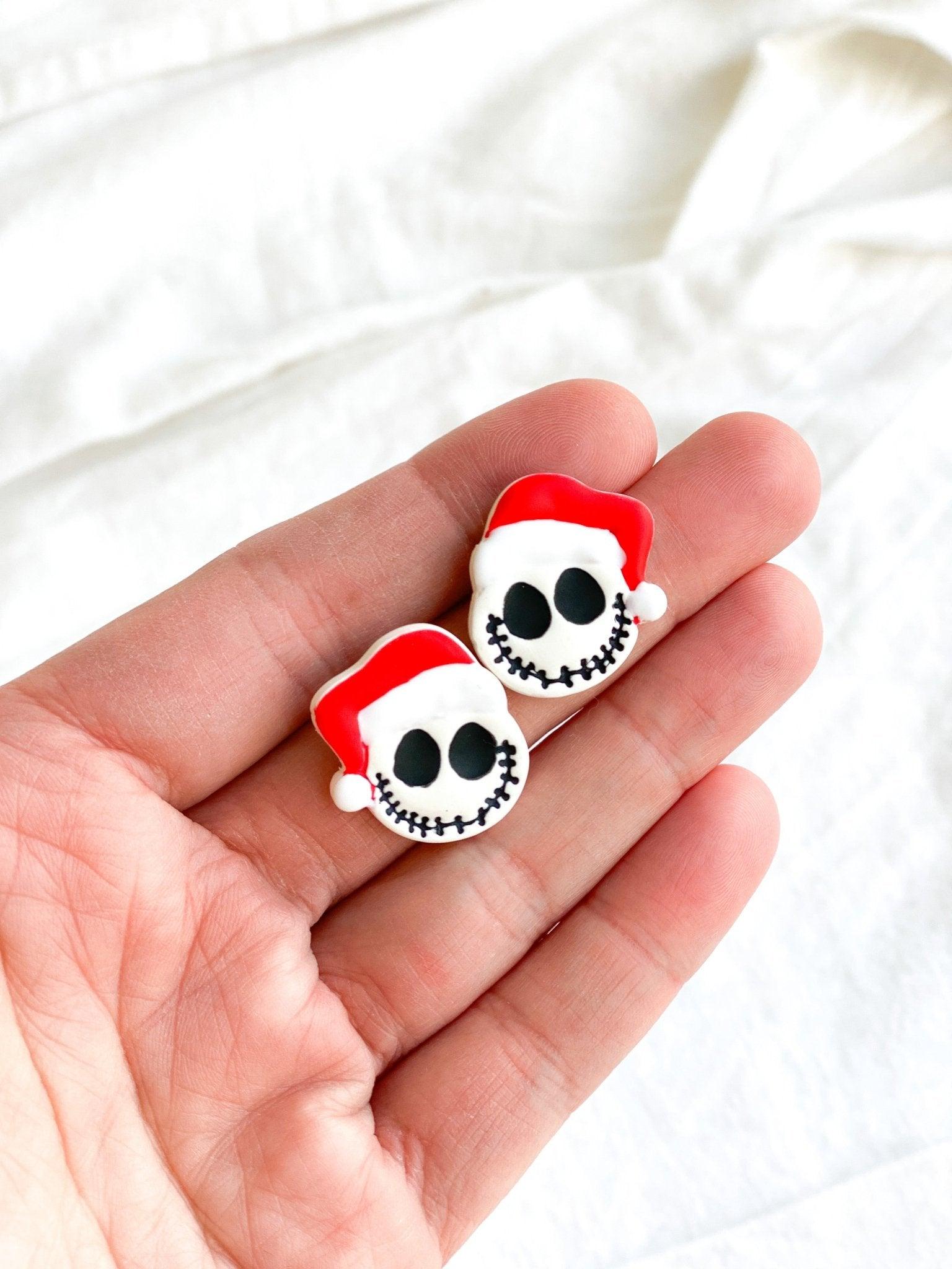 Handmade Jack Skellington with Santa Claus Hat Studs On Human Hand With White Cloth Background