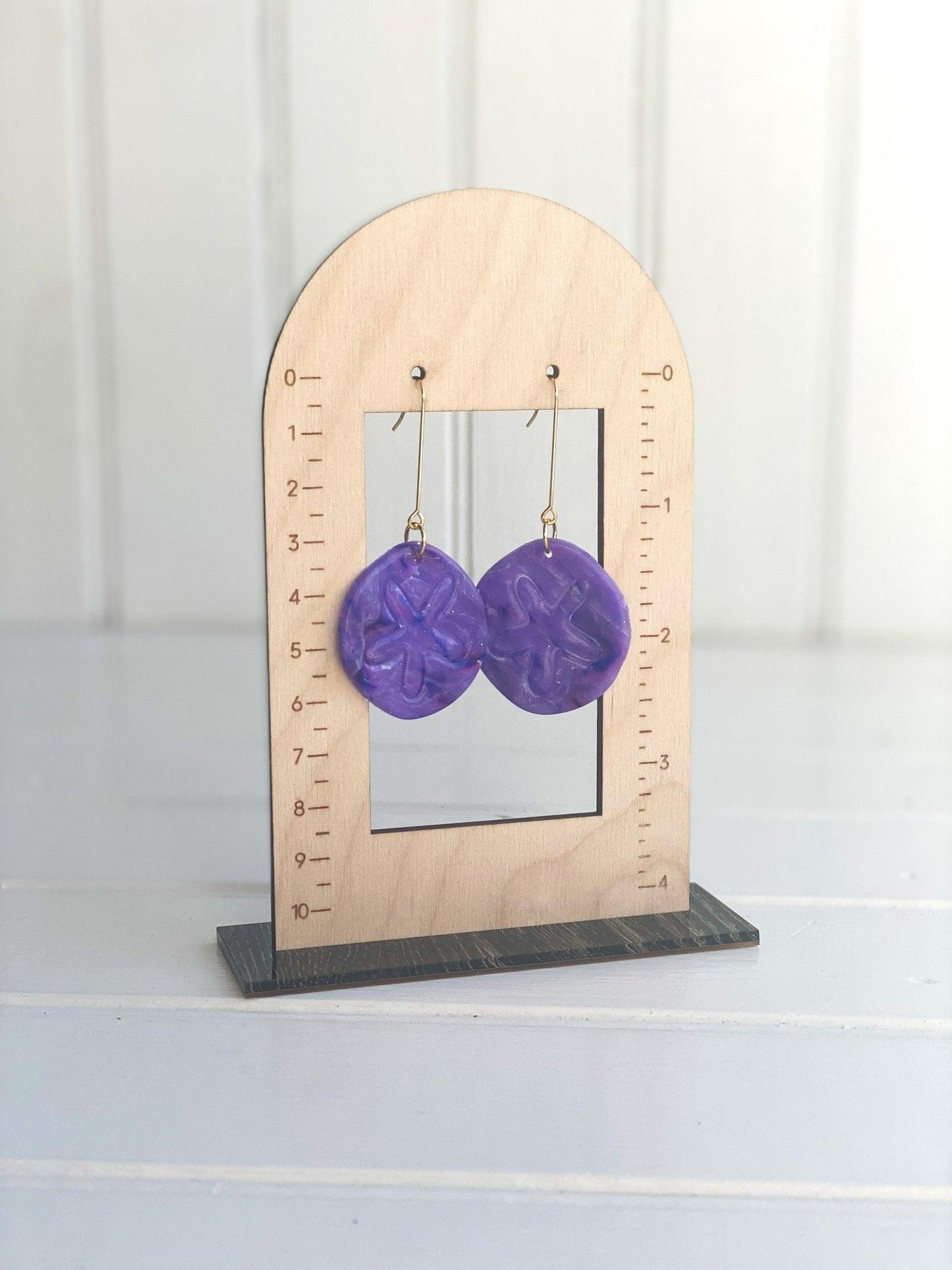 Handmade Bright Colored Sand Dollar Earrings on Long Surgical Steel Ear Wires displayed on Earring Measurement Stand