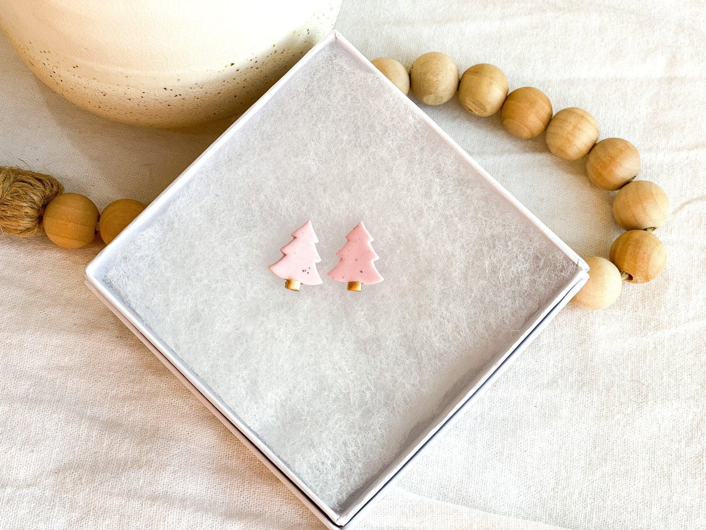 Light Pink Earrings shaped like Christmas trees made out of polymer clay and surgical steel posts in white gift box