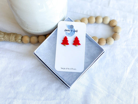 Red Stud Earrngs shaped like Christmas Trees with surgical steel posts on earring card in white gift box