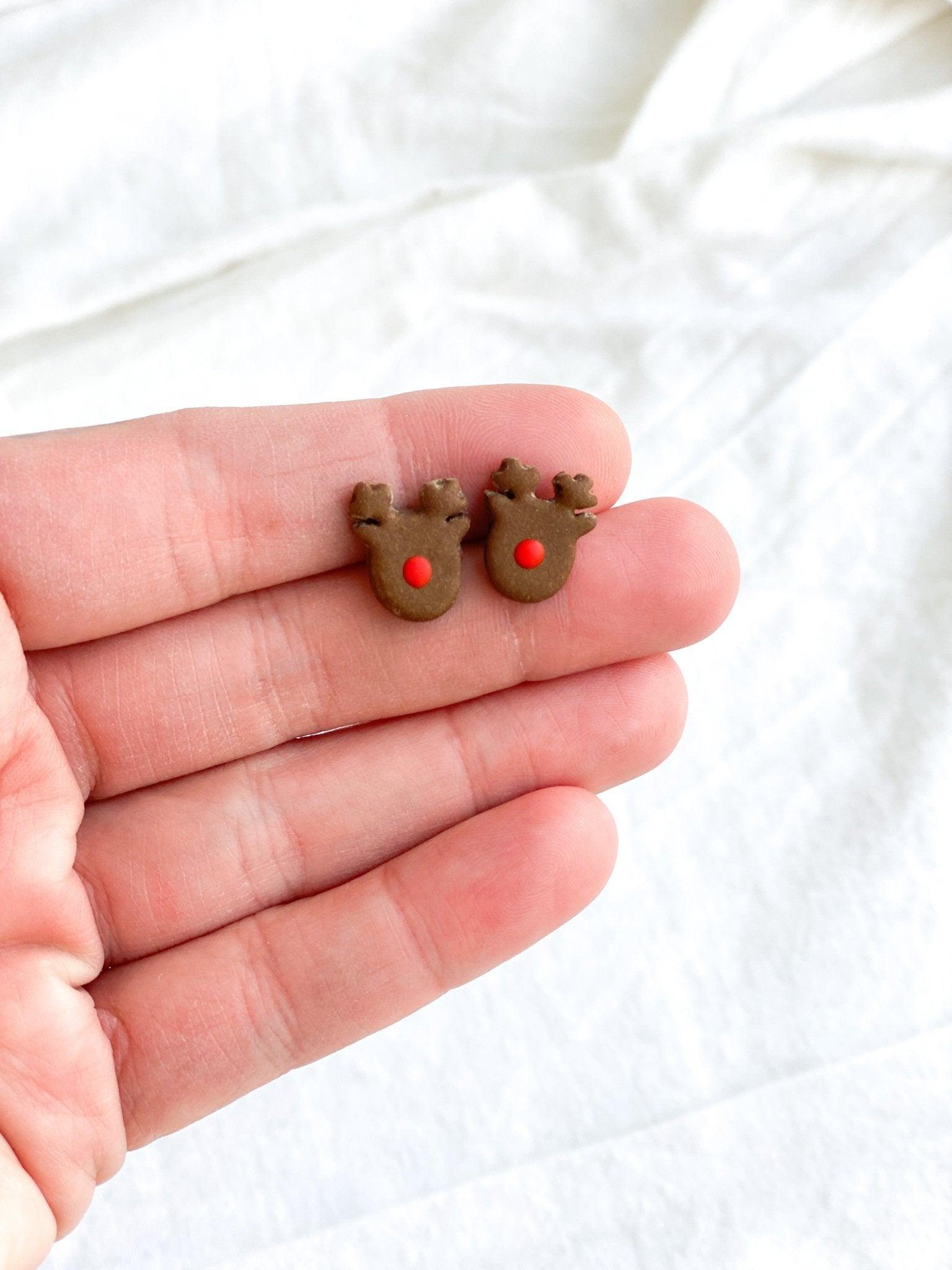 Cute handmade Rudolph Stud Earrings made from polymer clay and surgical steel posts held in human hand